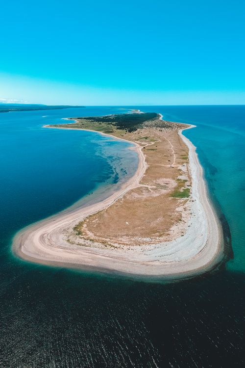 Free Aerial view of small island in colorful sea under blue sky in daylight Stock Photo