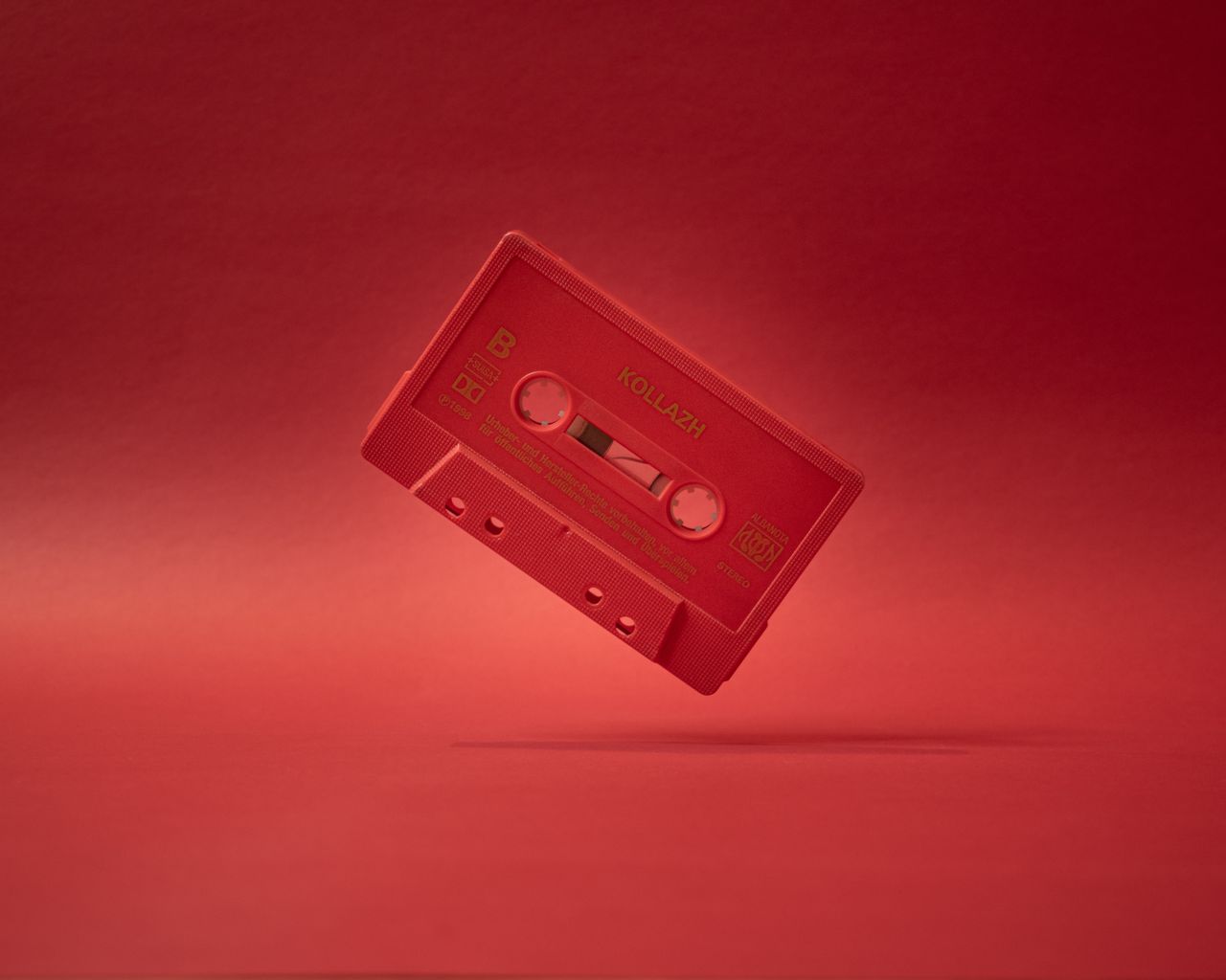 a red vintage cassette tape captivates in a minimalist studio shoot em