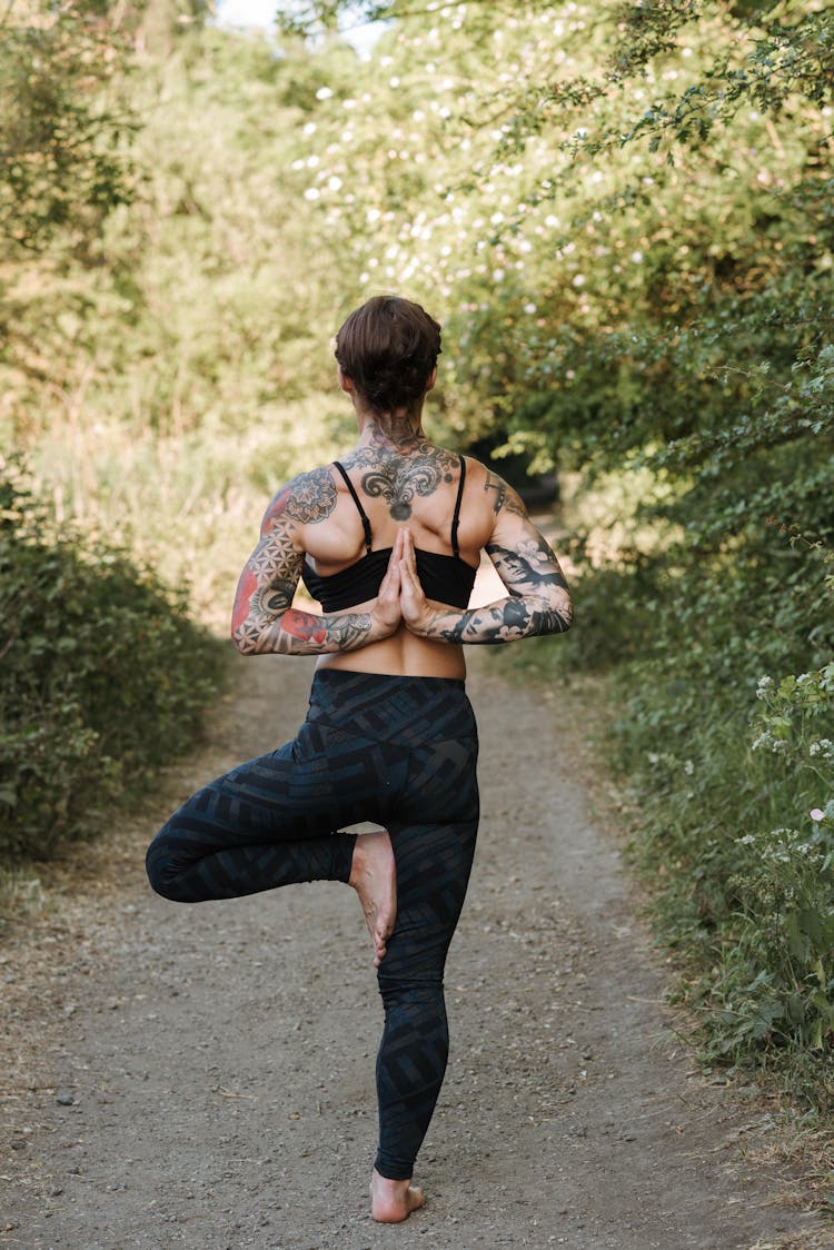 Unrecognizable Woman Showing Reverse Prayer Pose On Walkway