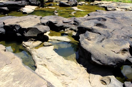 Free A tranquil rocky landscape with shallow pools reflecting the sky, perfect for exploring nature's beauty. Stock Photo