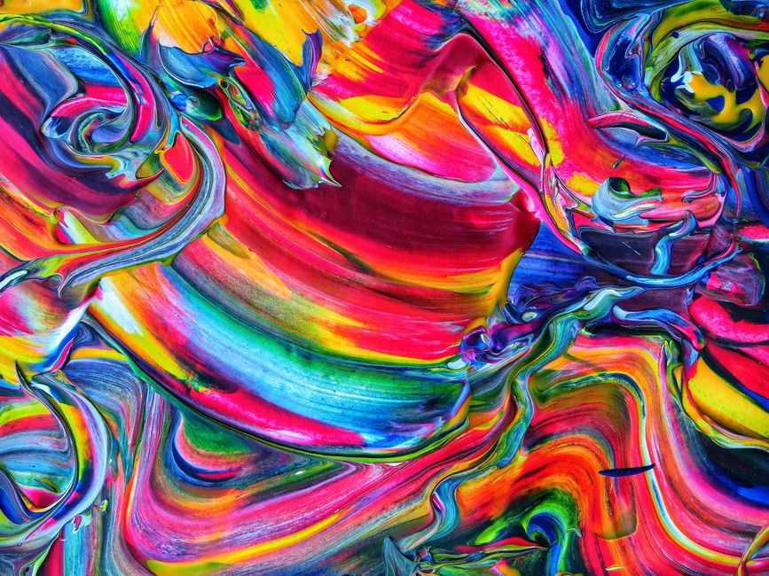 Colorful swirling acrylic paint creating vibrant abstract patterns and textures.