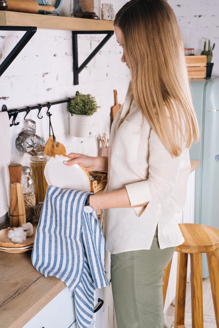 A Woman Wiping The Plate