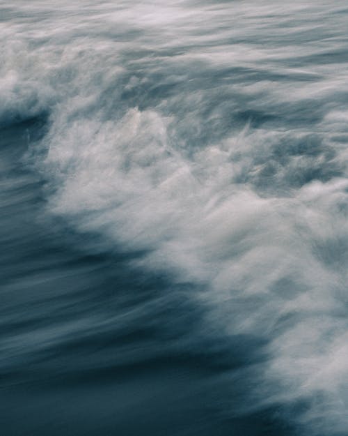 Sea with splashing foamy waves in evening