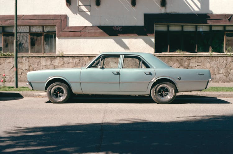 A Sedan Vintage Car Parked On The Road