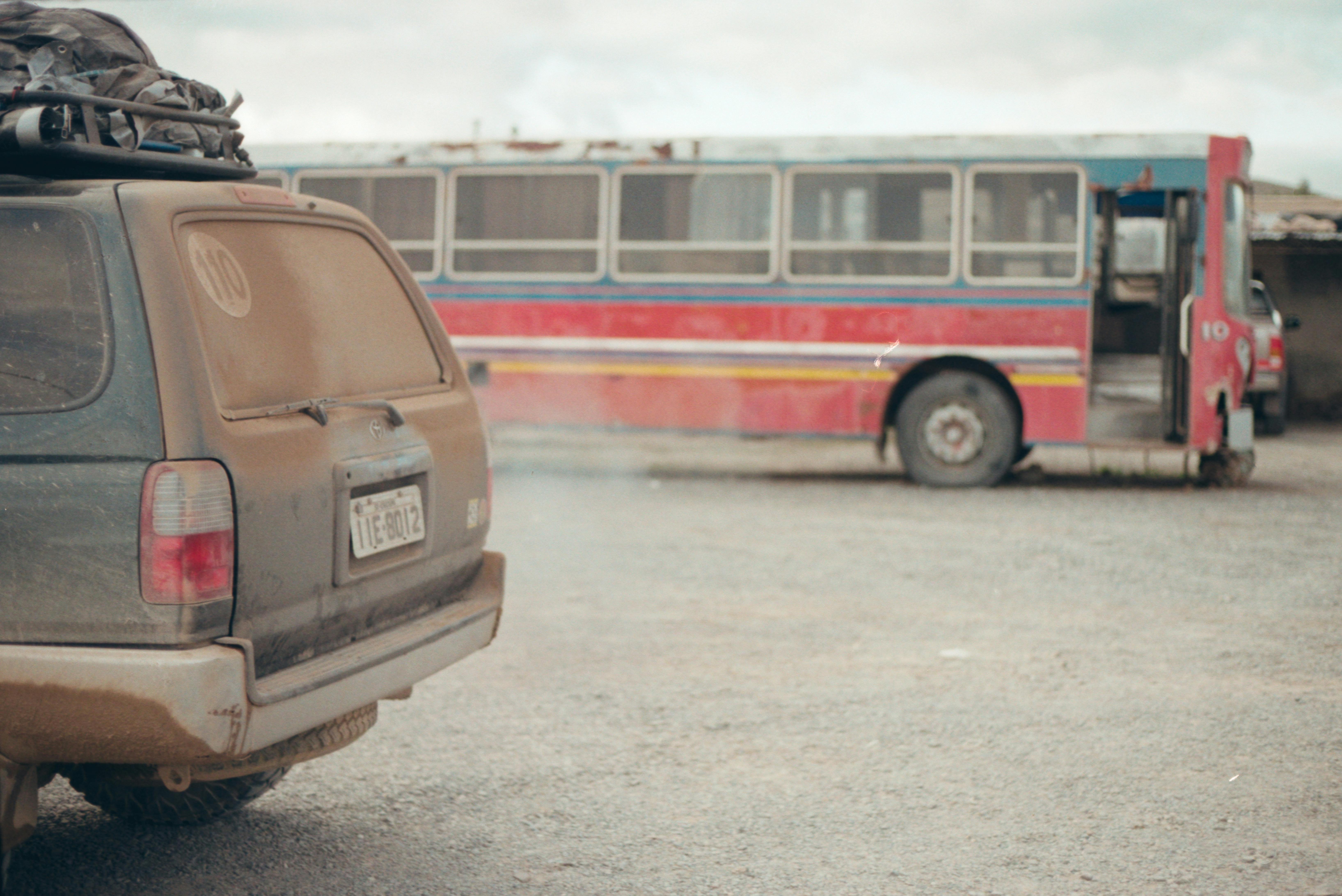 a dirty car and an abandoned bus