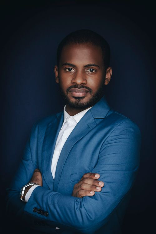 Free Stylish portrait of a man wearing a blue suit against a dark background. Stock Photo