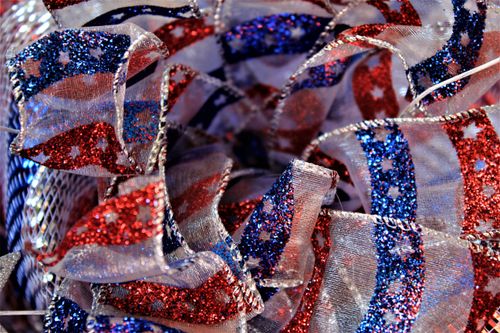 Free Close-up of a red, white, and blue sparkling ribbon, perfect for festive decorations. Stock Photo