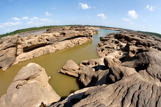 Photo by icon0 com Stunning view of a rocky river landscape under a clear blue sky, ideal for nature lovers.