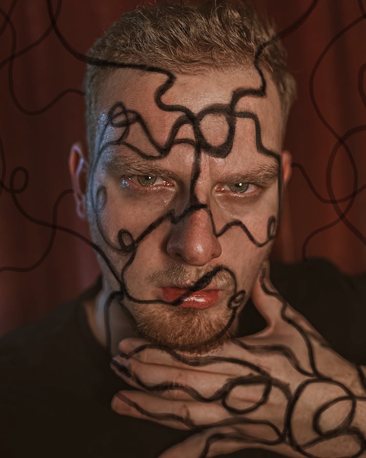 Serious Male Model With Curvy Black Lines Painted On Skin