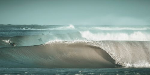 Surfers Surfing on Ocean Waves