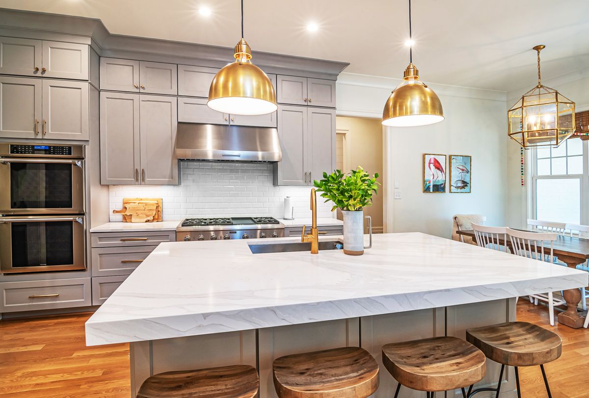 After: Luxury renovated kitchen with marble island and custom cabinetry