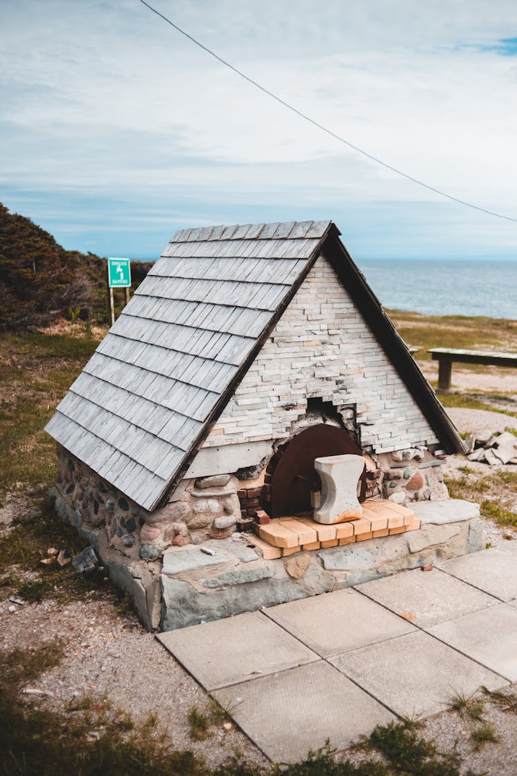 Stone Outdoor Oven On Shabby Land Near Sea