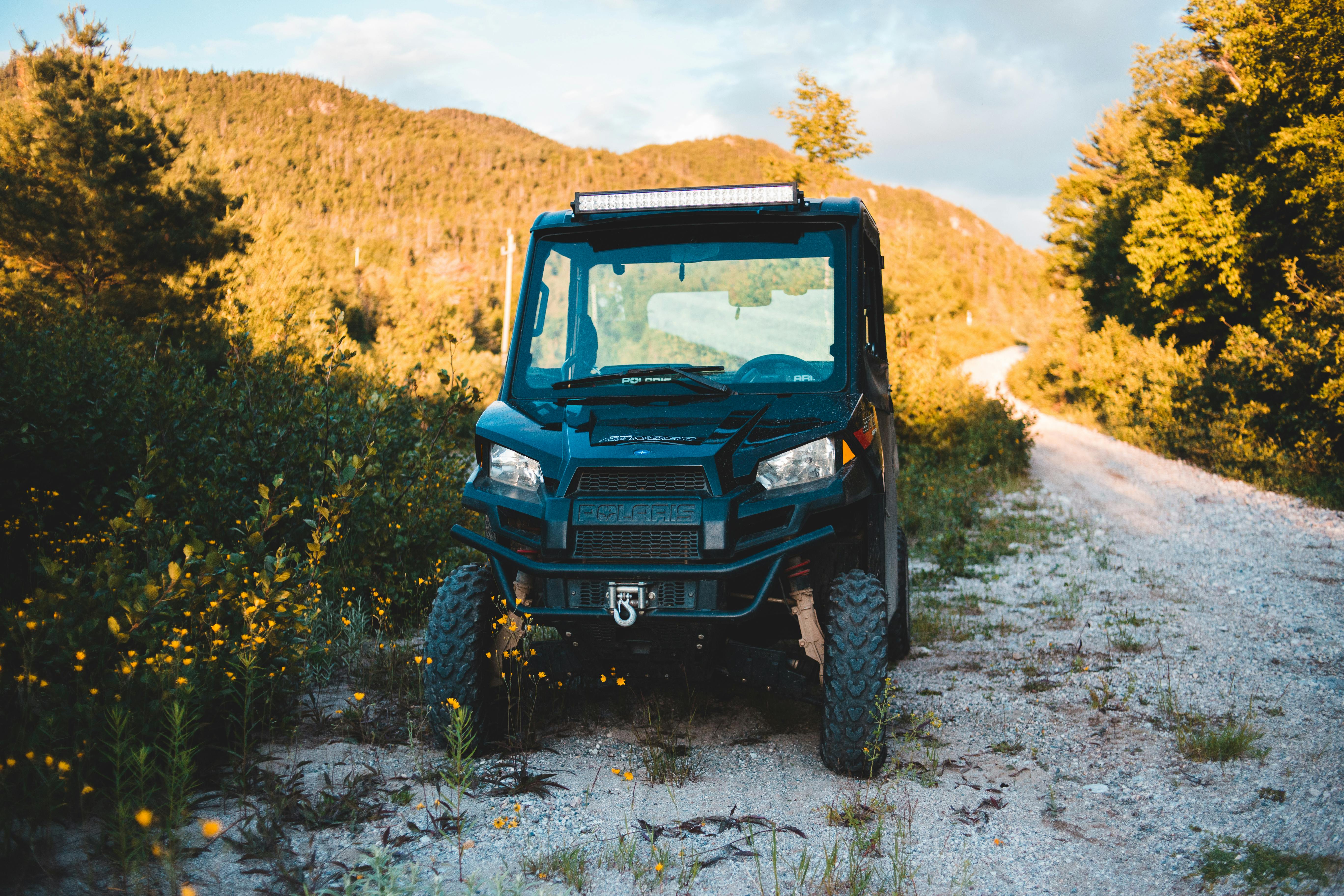 ATV Parked Near Narrow Walkway Between Colorful Trees On Mountain ...