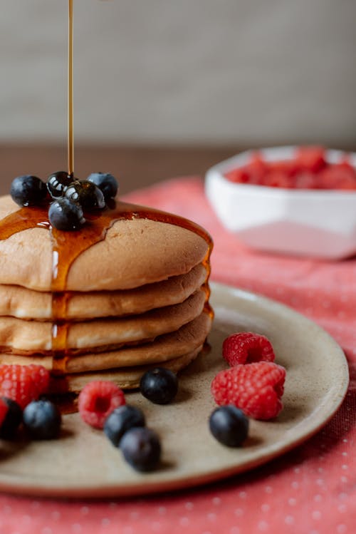 Pile of delicious pancakes with fresh berries