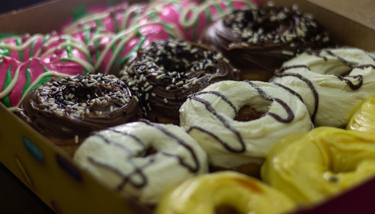 A Box Of Donuts In Different Flavors