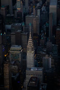 Stunning aerial view of the iconic Chrysler Building illuminated at night in New York City.