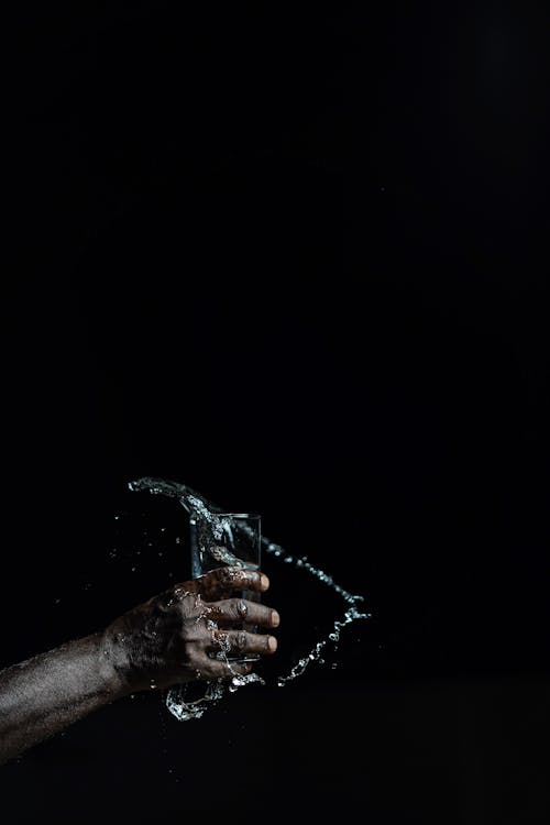 Free A Person Holding a Glass of Water Stock Photo