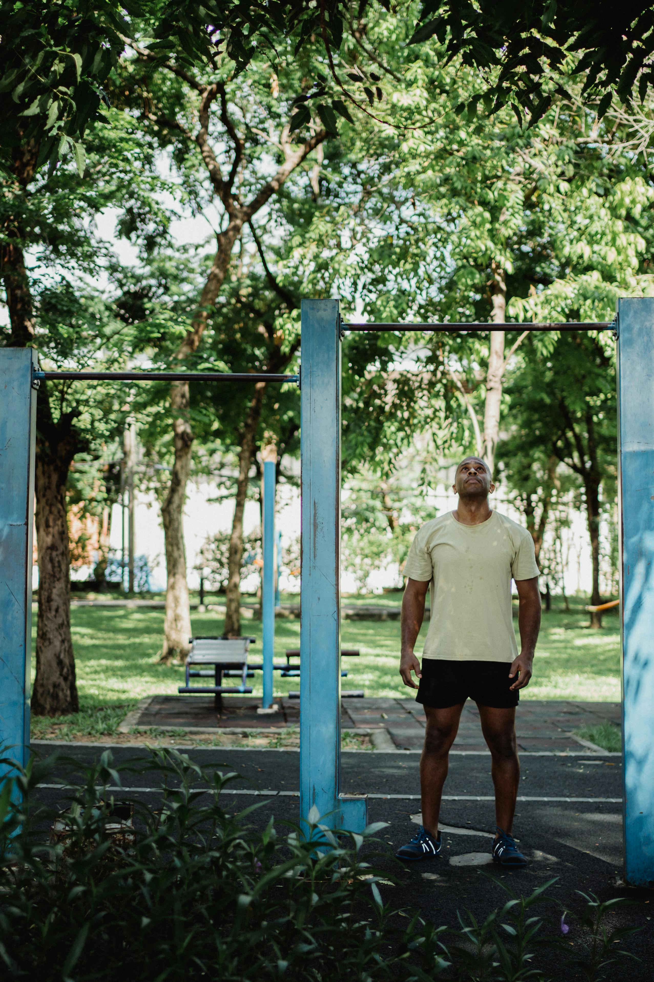 A Man Standing Below the Pull up Bar