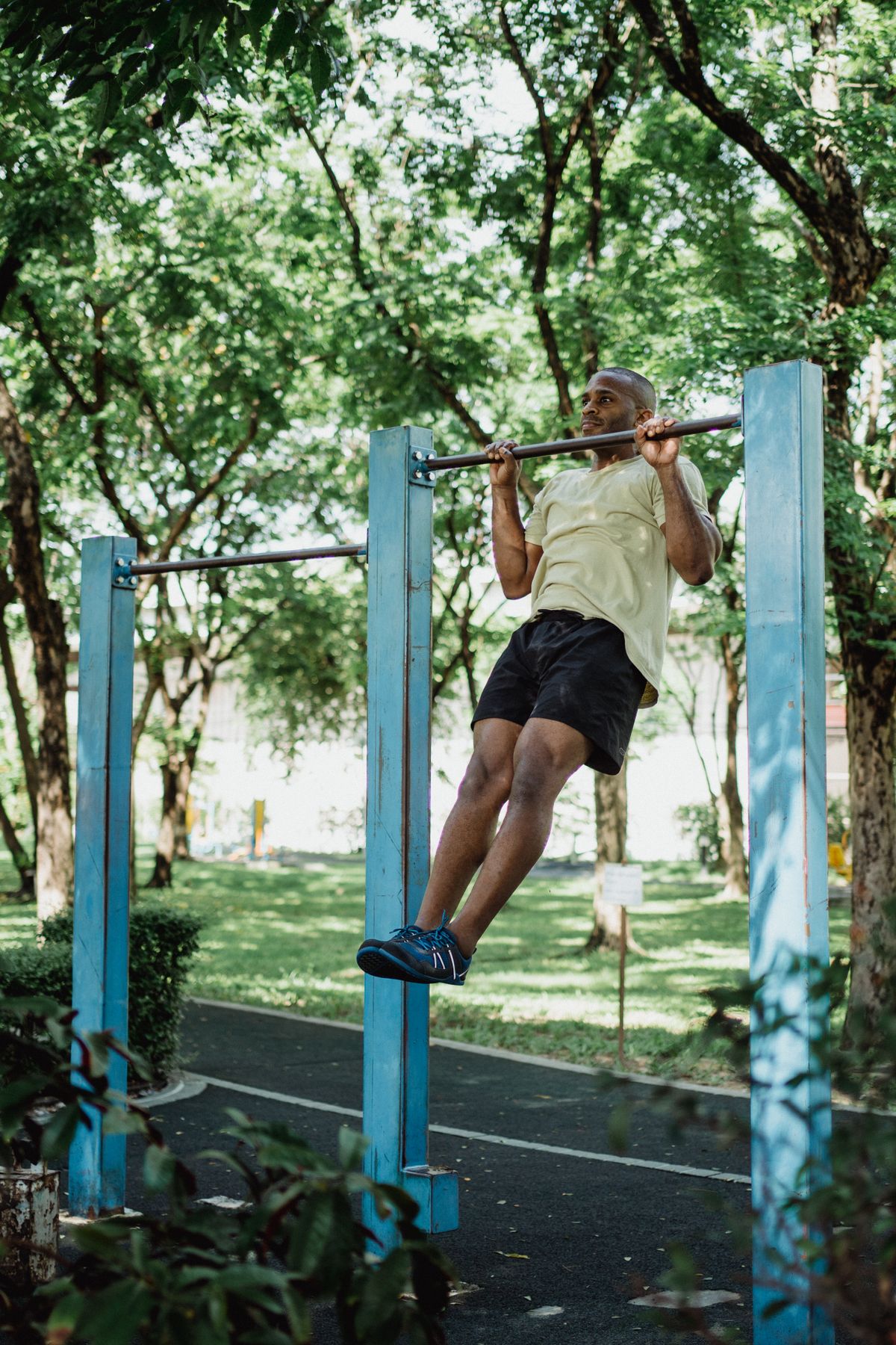 African American man performing pull-ups outdoors