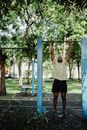 A Man Hanging on a Pull-up Bar