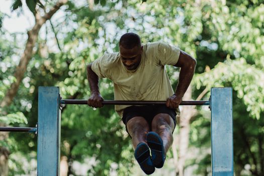 A Man Lifting Himself Over the Pull-up Bar