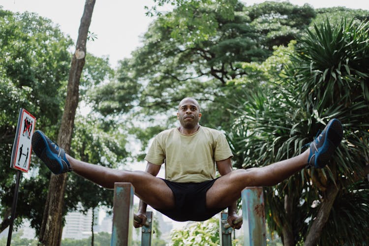 A Man Using A Parallel Bars In Exercising