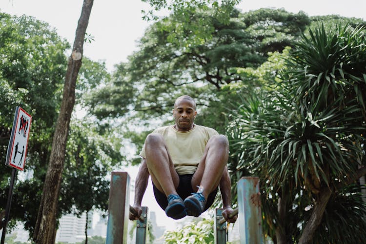 
A Man Doing A Leg Raise On A Dip Bar