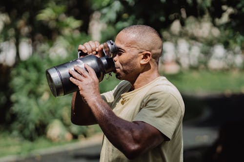 
A Man Drinking from a Tumbler
