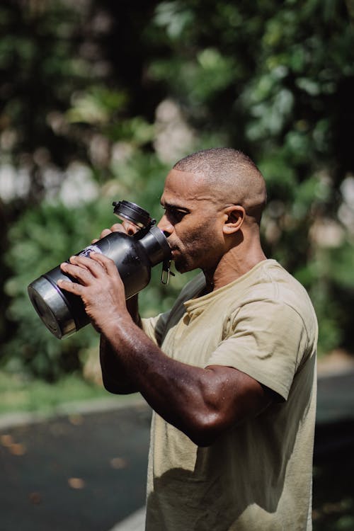 
A Man Drinking from a Tumbler