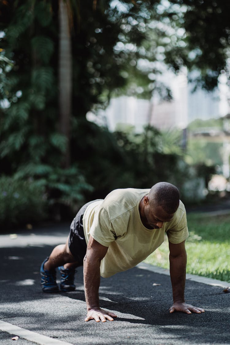 An Athletic Man Planking In The Park