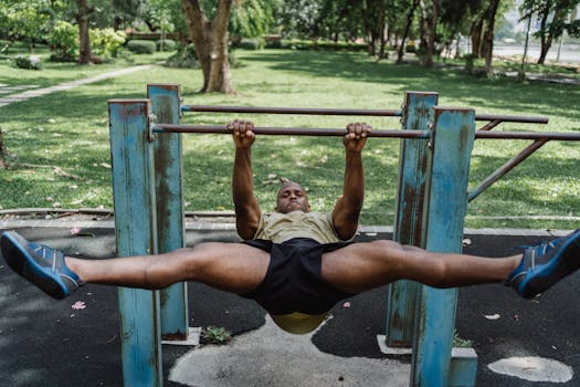 A fit man exercising on parallel bars in a green park, demonstrating strength and fitness.