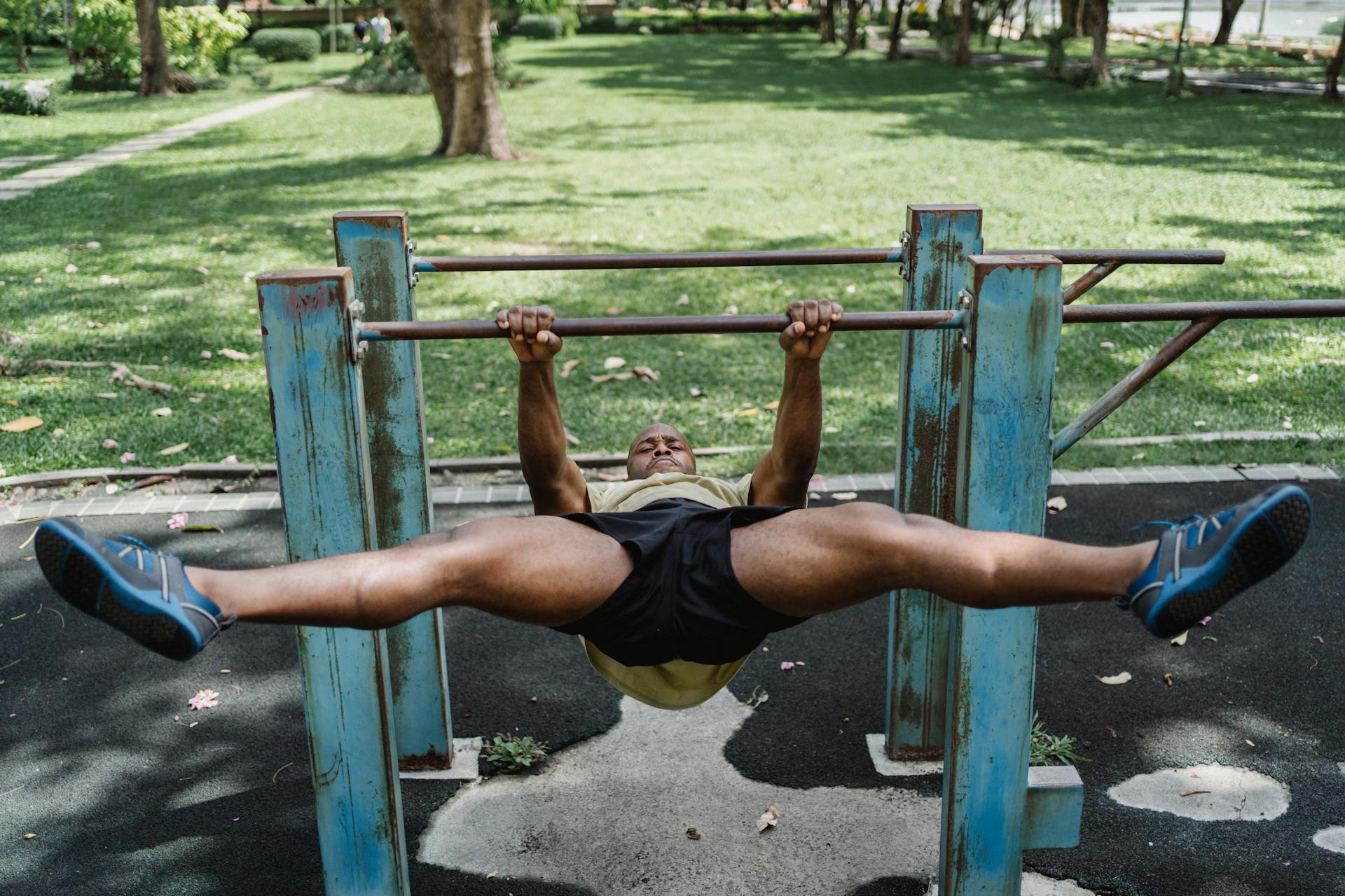 Man with Open Legs Pulling Up His Weight on a Bar