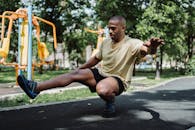 A Man Balancing Himself Using Only His One Leg