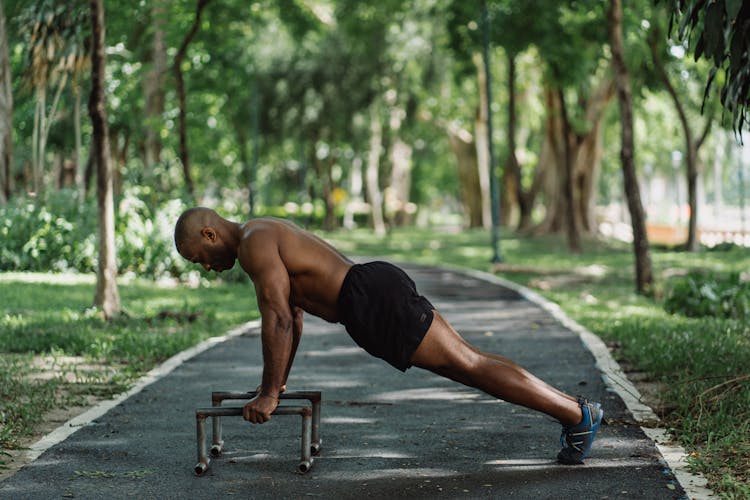 Shitless Man On Doing Push Ups On The Parallel Low Dip Bars