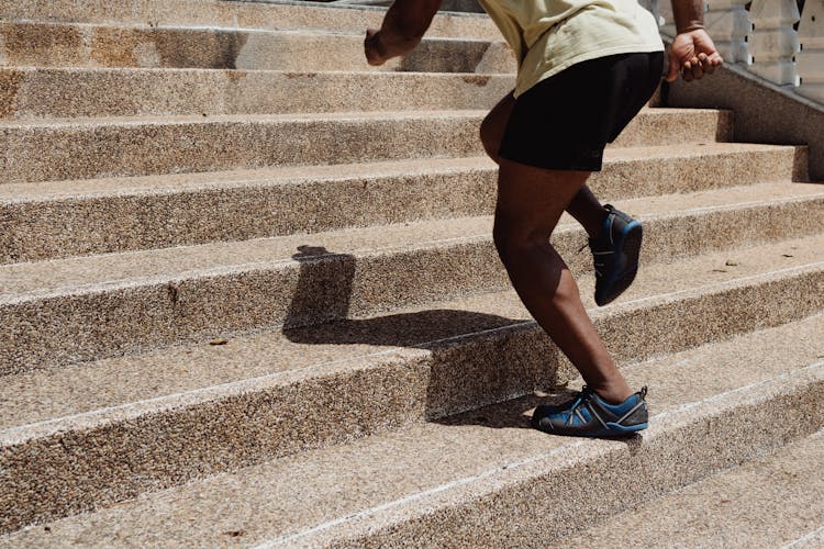 Person Climbing The Concrete Stairs