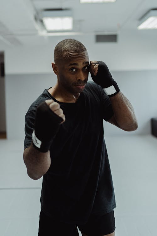 Free Portrait of a Man in Boxing Position with Bandage on His Hands Stock Photo