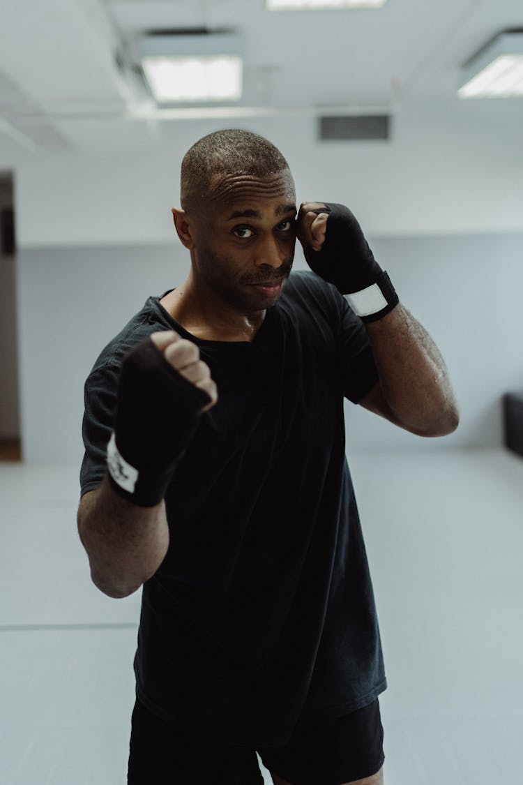 Portrait Of A Man In Boxing Position With Bandage On His Hands