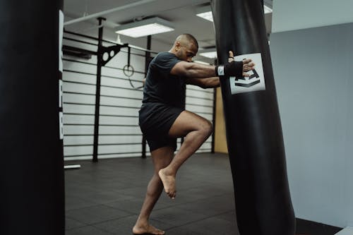 Free A Kickboxer Holding the Punching Bag  Stock Photo