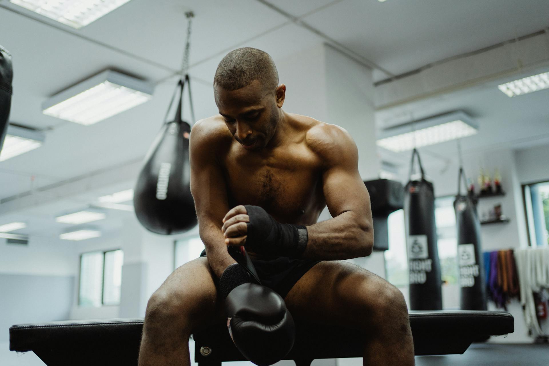 Shirtless Man Wearing Black Boxing Gloves