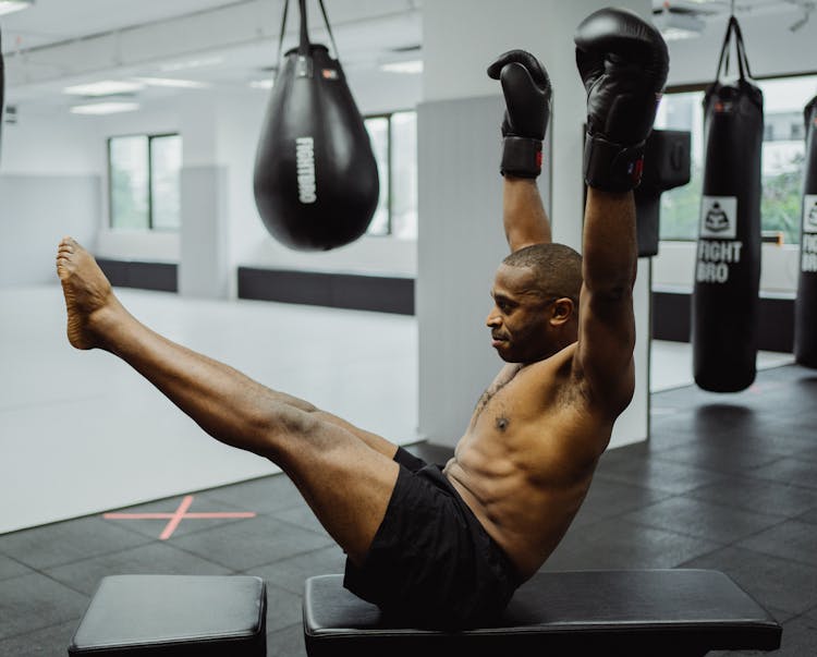 Man Sitting Raising His Arms And Legs 