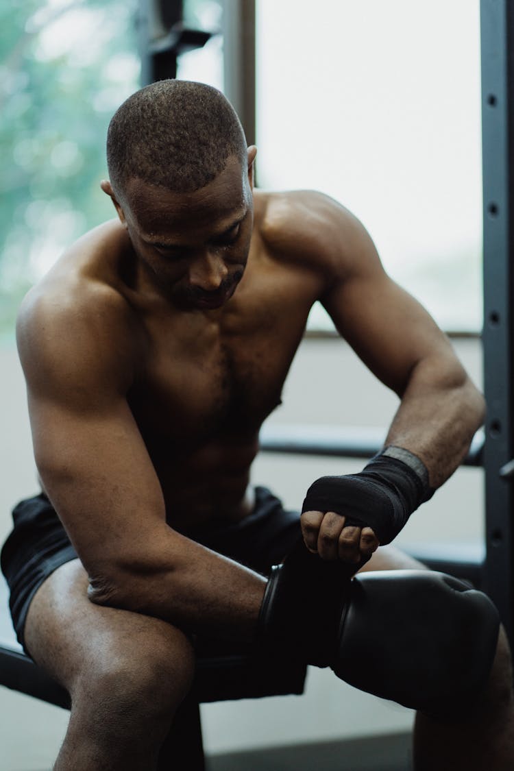 Serious Face Man Putting On His Boxing Gloves