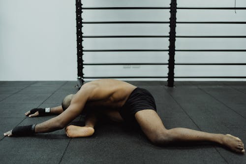 Free Man Stretching on the Floor  Stock Photo