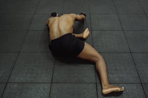 Free Man Stretching on the Floor  Stock Photo