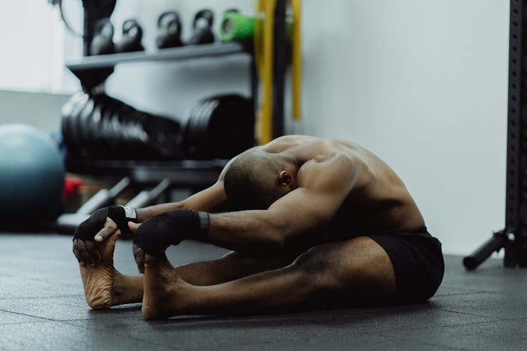 Man Sitting Stretching His Legs And Arms 