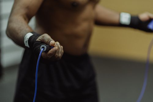 Free Focused shot of a man's hand holding a jump rope, emphasizing fitness and training. Stock Photo