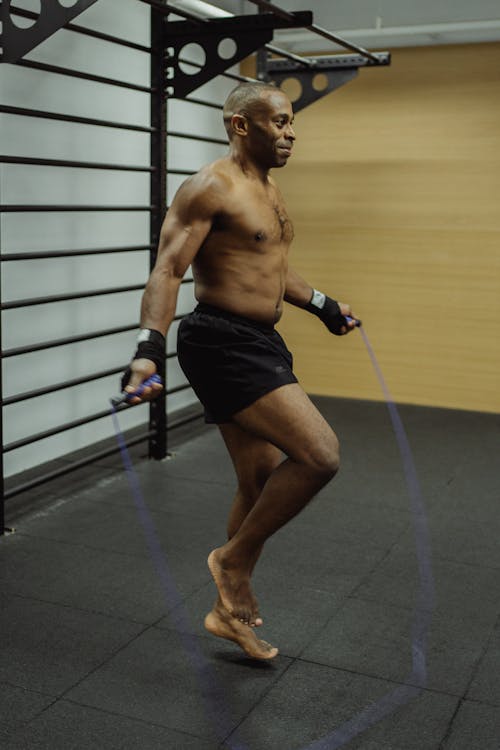 Man Working Out Using A Blue Jumping Rope