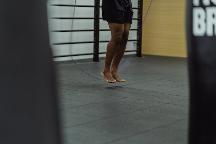 Barefooted Person Jumping On The Blue Rope 