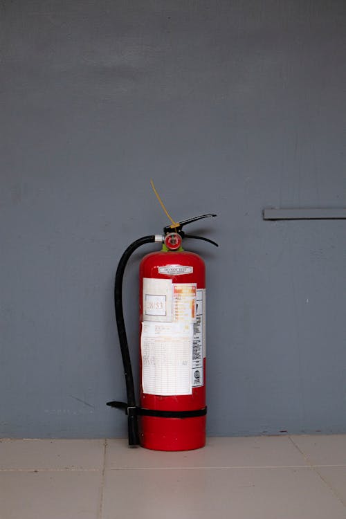 Red Fire Extinguisher Against Wall