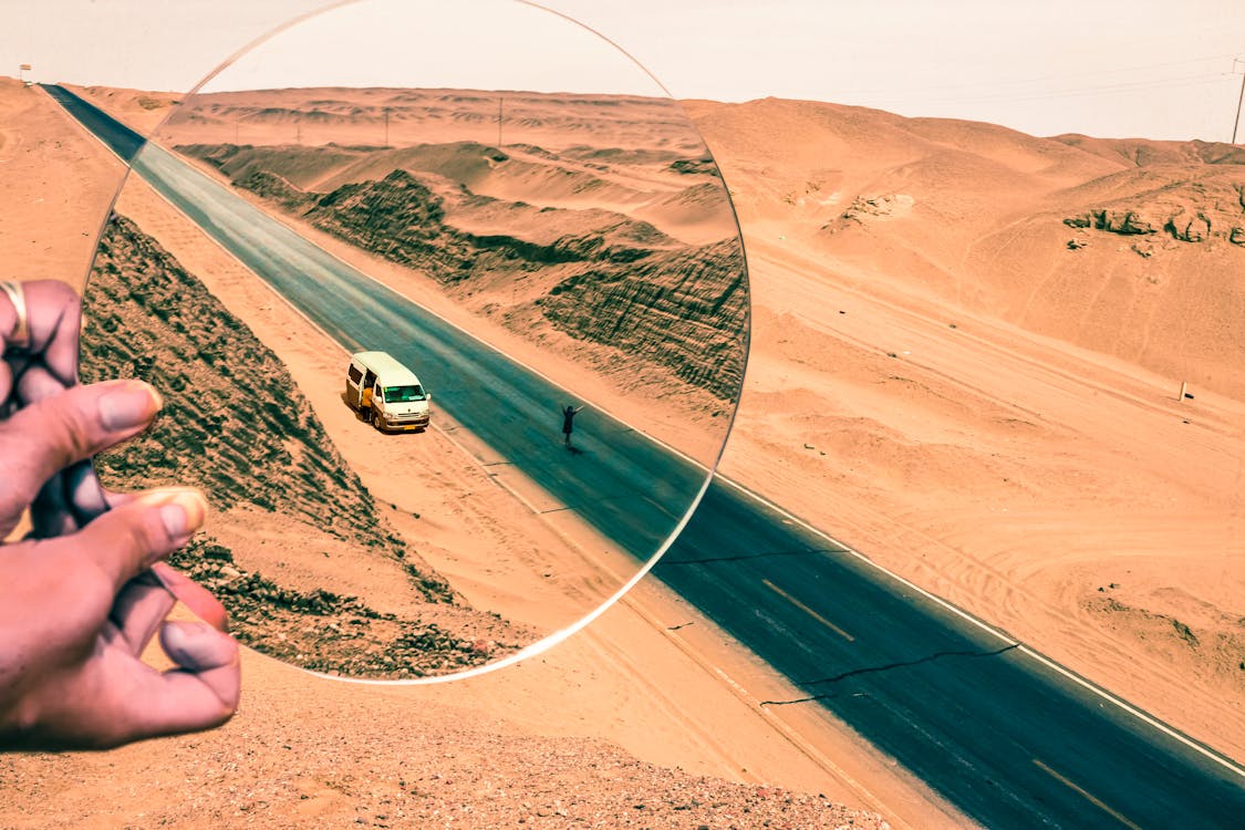 Free Road in Desert and Magnifying Glass  Stock Photo