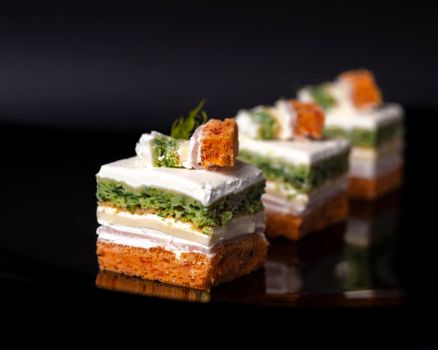 Stylish and delicious layered tartines with cheese and herbs on a sleek black background. Perfect for gourmet dining imagery.